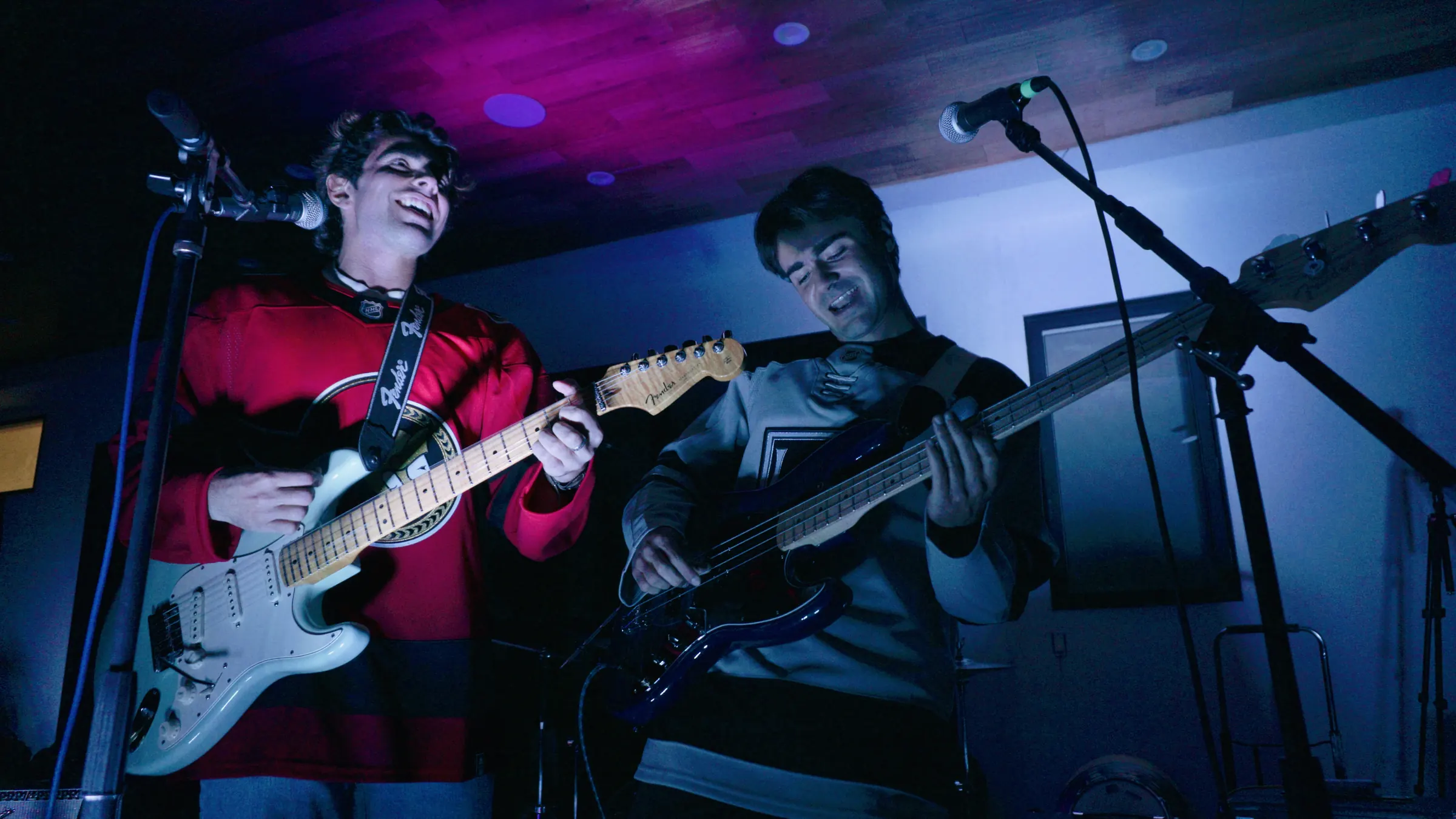 Stoke Club's guitarist and bassist singing together on stage