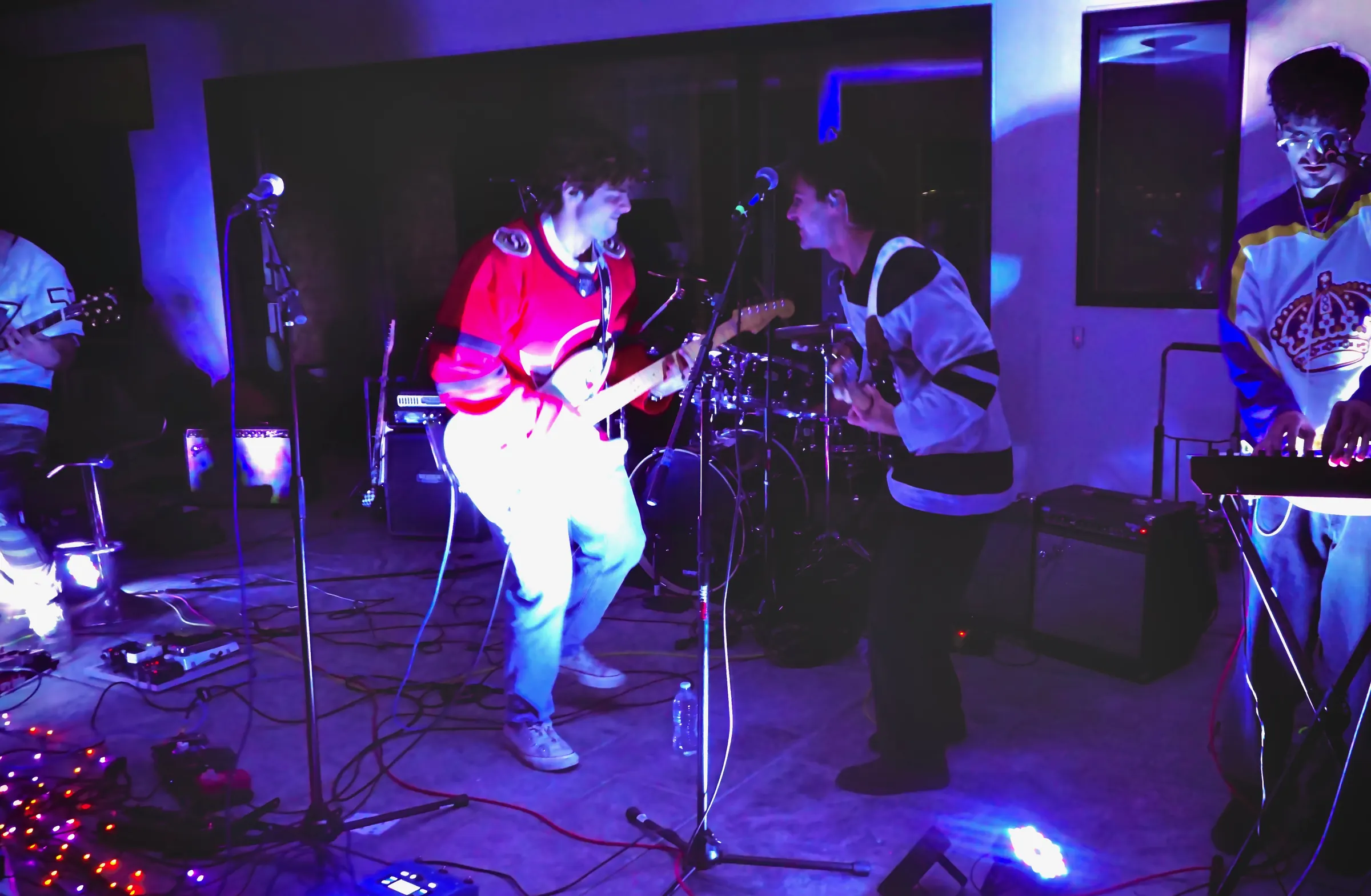 Stoke Club playing a house party in blue and red light